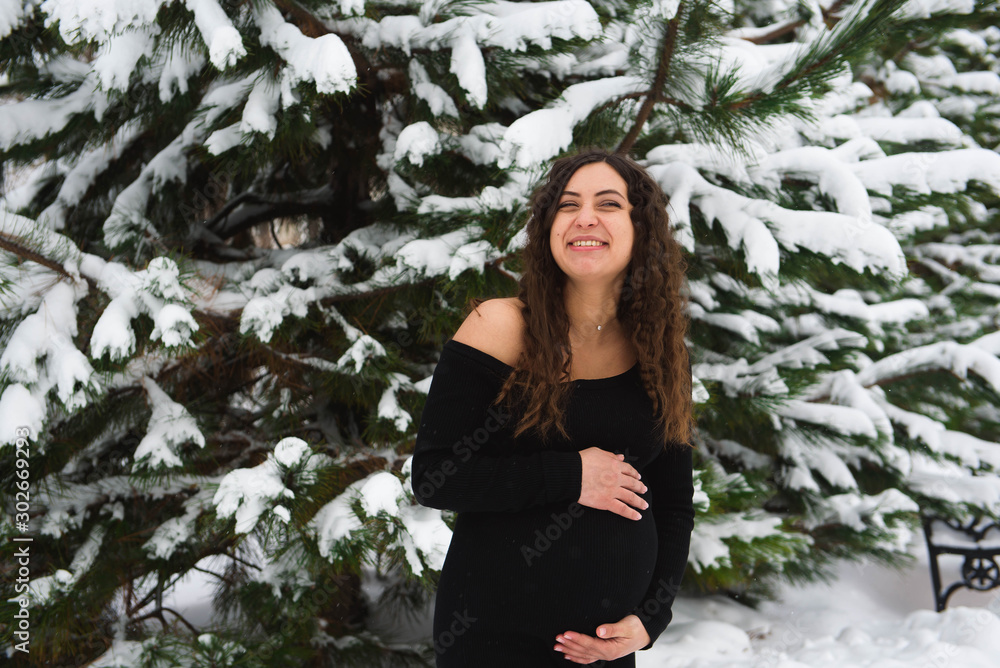 Young happy pregnant woman in snowy forest Young happy pregnant woman in snowy forest