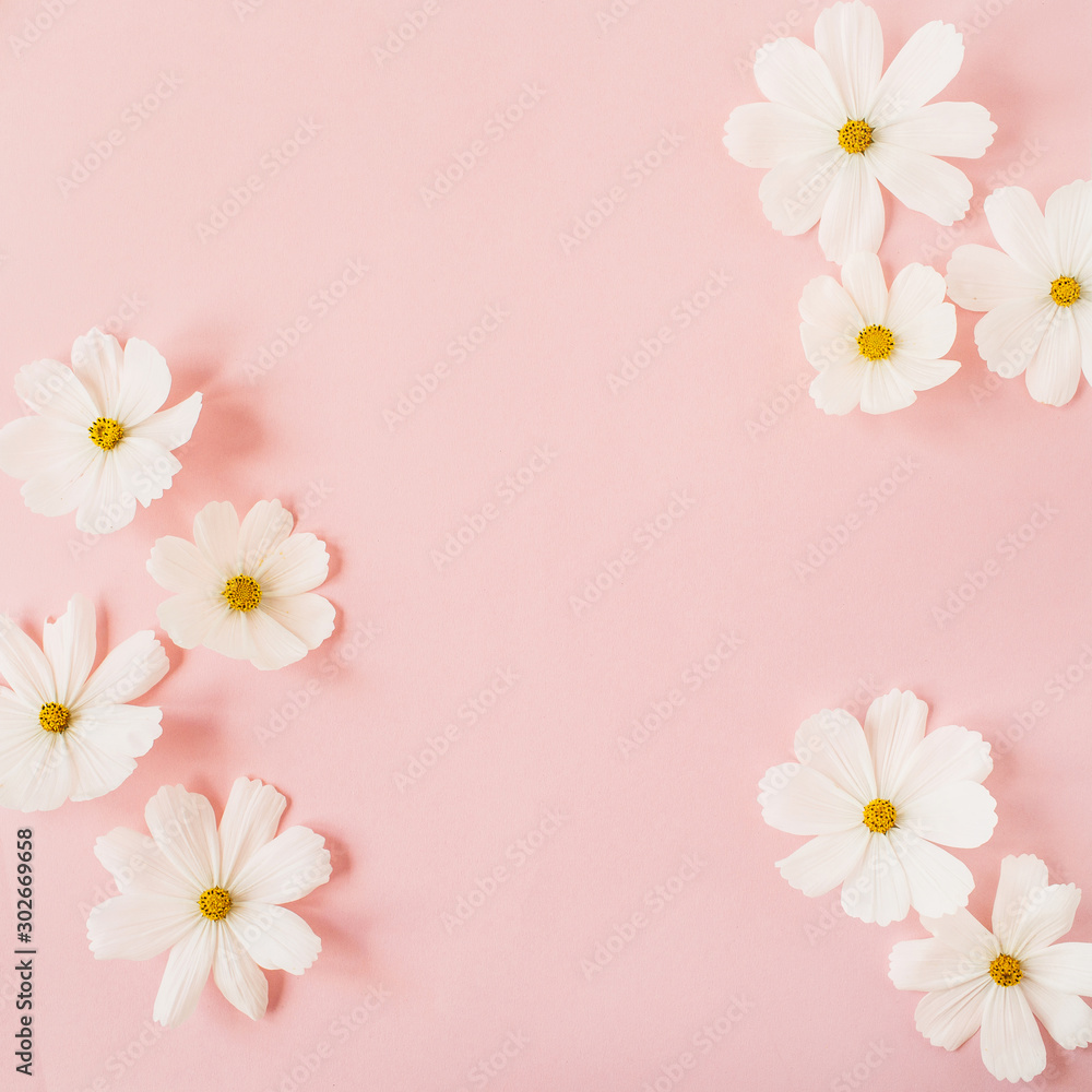 Minimal styled concept. White daisy chamomile flowers on pale pink background. Creative lifestyle, summer, spring concept. Copy space, flat lay, top view.