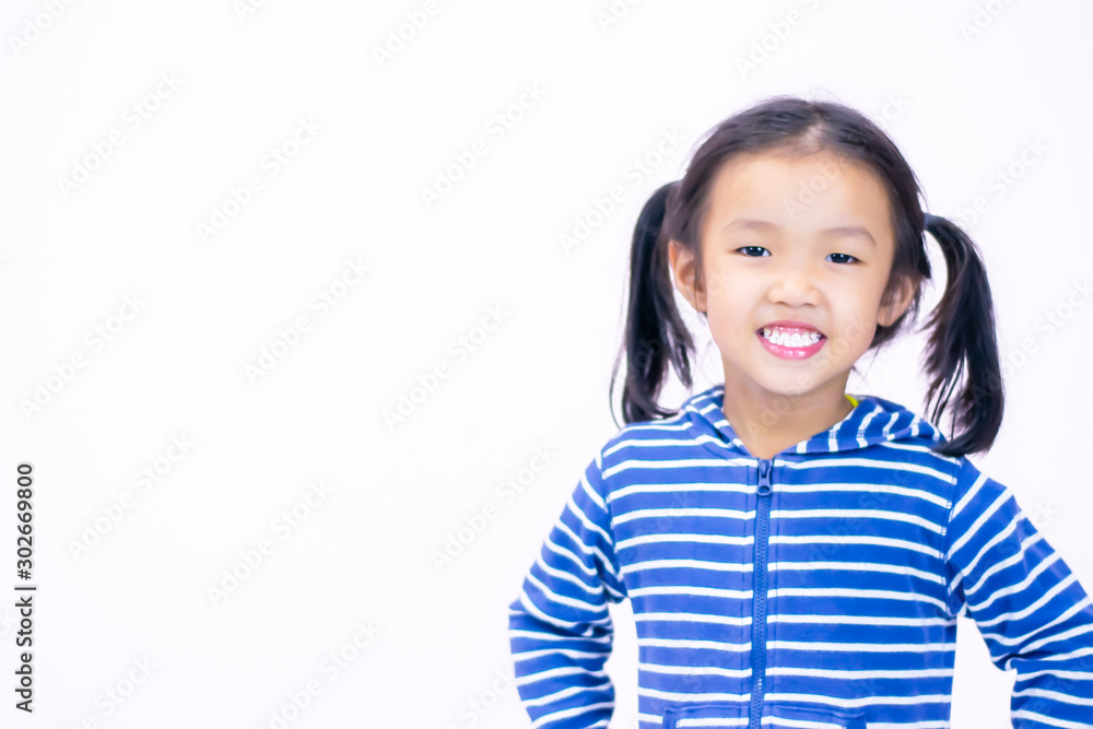 A little girl with a smiling face, aged three and a half wearing a blue sweate A little girl with a smiling face, aged three and a half wearing a blue sweate