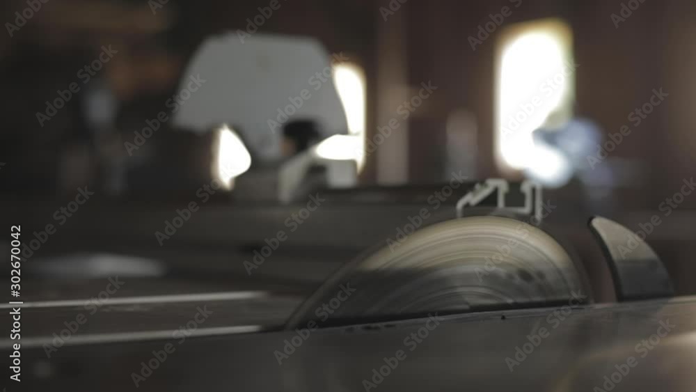 Carpenter cutting wood with a circular saw