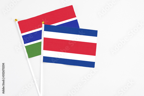 Costa Rica and Georgia stick flags on white background. High quality fabric, miniature national flag. Peaceful global concept.White floor for copy space.