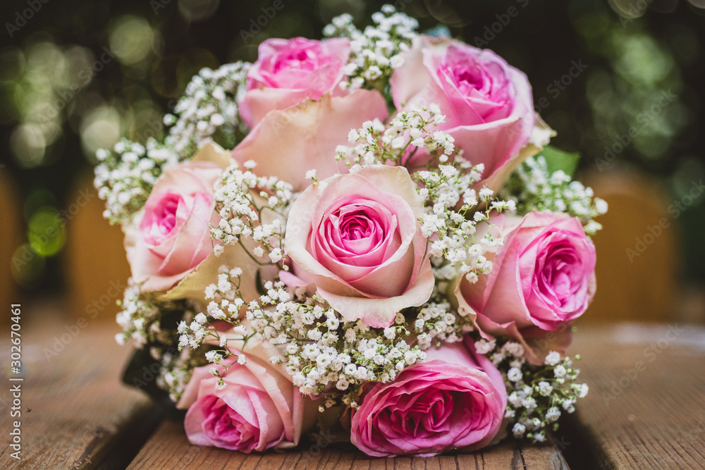 Wedding bouquet with pink roses on wooden table. Wedding bouquet with pink roses on wooden table.