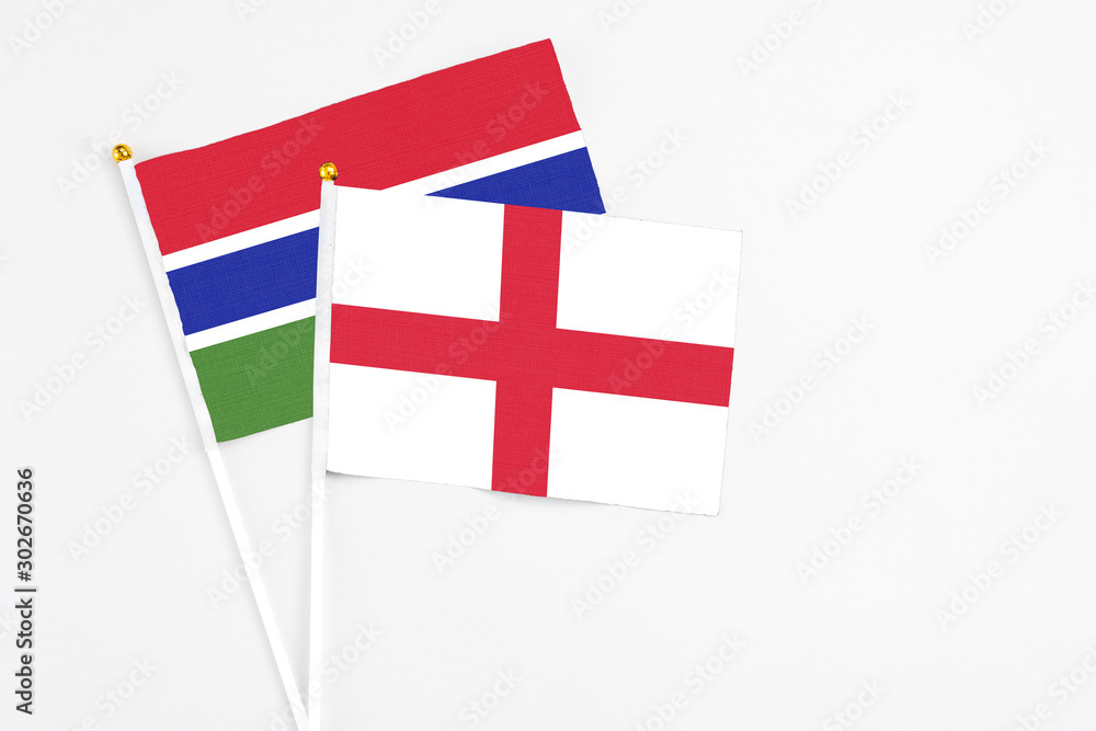 England and Georgia stick flags on white background. High quality fabric, miniature national flag. Peaceful global concept.White floor for copy space.