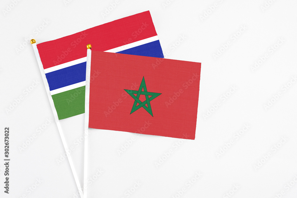 Morocco and Georgia stick flags on white background. High quality fabric, miniature national flag. Peaceful global concept.White floor for copy space. Morocco and Georgia stick flags on white background. High quality fabric, miniature national flag. Peaceful global concept.White floor for copy space.