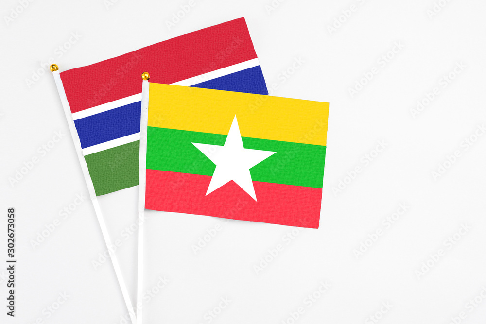 Myanmar and Georgia stick flags on white background. High quality fabric, miniature national flag. Peaceful global concept.White floor for copy space.