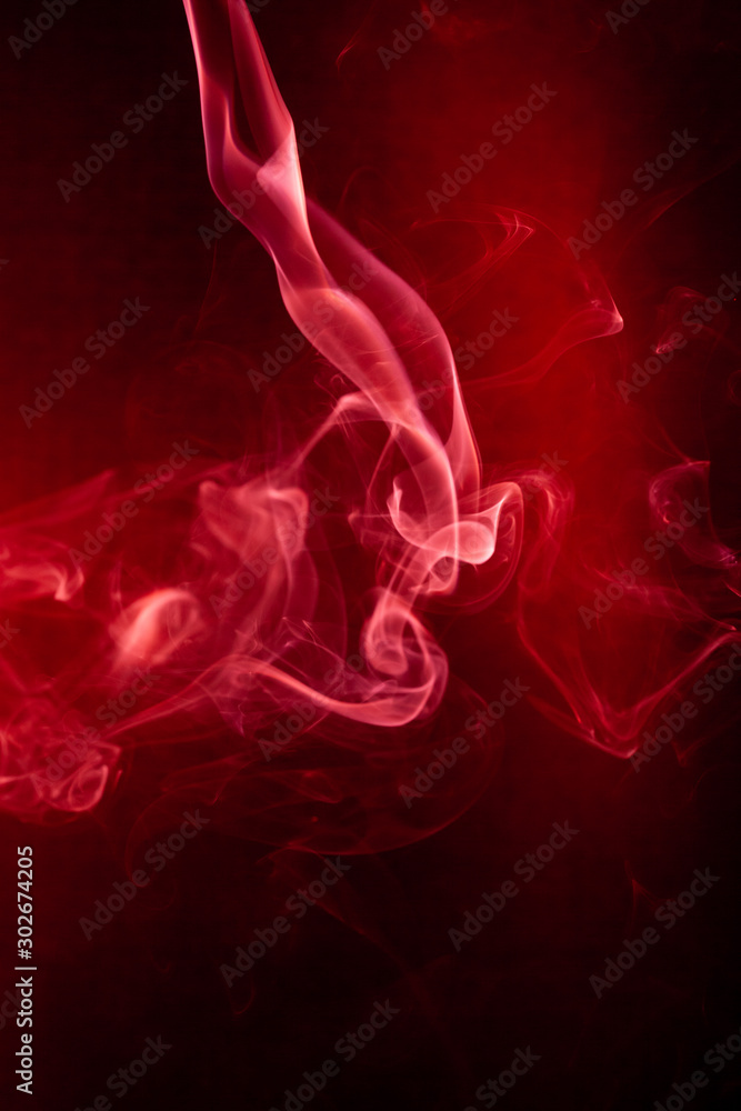 Fototapeta premium Red smoke motion on black background.