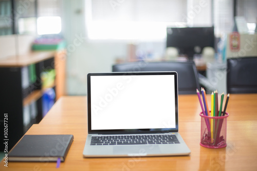 Computer laptop with white blank screen isolated  on work table in office.