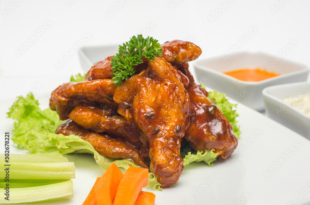 Barbecue chicken wings with vegetables and sauces Barbecue chicken wings with vegetables and sauces