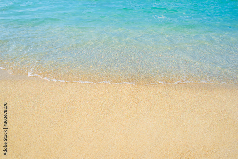 Ocean waves on the beach and blue water in Phuket, Thailand during the high season. Holidays and travel