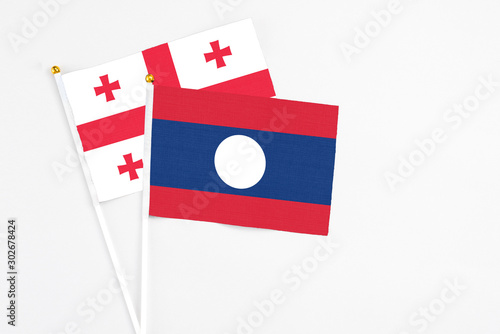 Laos and Georgia stick flags on white background. High quality fabric, miniature national flag. Peaceful global concept.White floor for copy space. Free Download Laos and Georgia stick flags on white background. High quality fabric, miniature national flag. Peaceful global concept.White floor for copy space. - GFXLoad