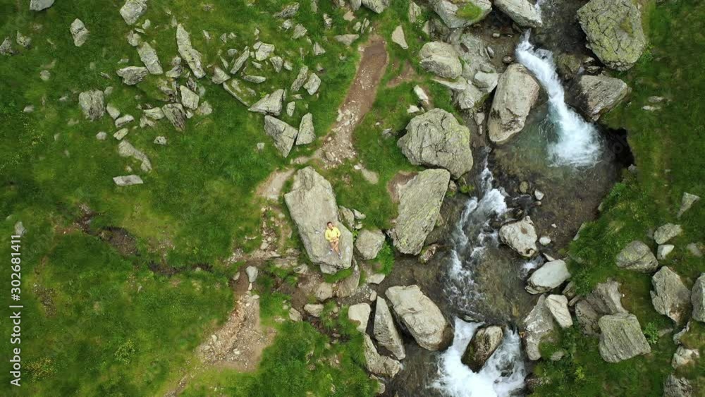 River and Rocks in Romanian Mountrains with young hiker River and Rocks in Romanian Mountrains with young hiker