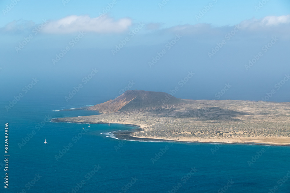 View from Lanzarote over the Atlantic with La Graciosa Island covered in calima