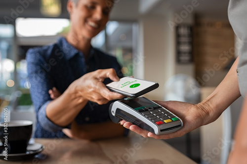 Woman paying using NFC technology photo
