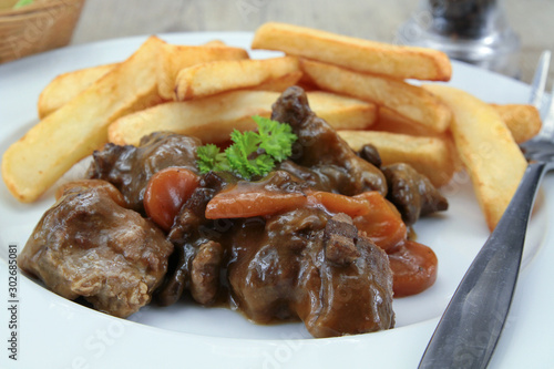 bourguignon beef and fries on a plate