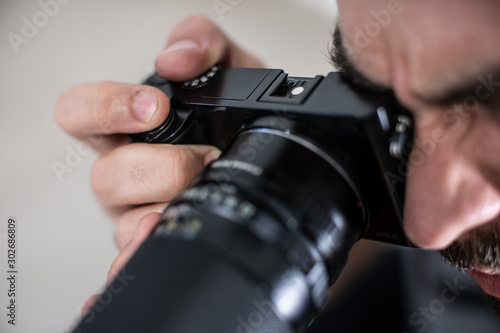 photographer with camera isolated on white taking a picture shooting studio session working focusing hand teach learn practice class photo