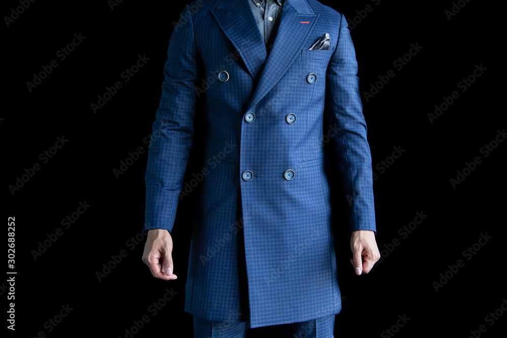 Asian businessman in a blue suit is standing on a black background. Man in a blue coat standing on a black background. Asian businessman in a blue suit is standing on a black background. Man in a blue coat standing on a black background.
