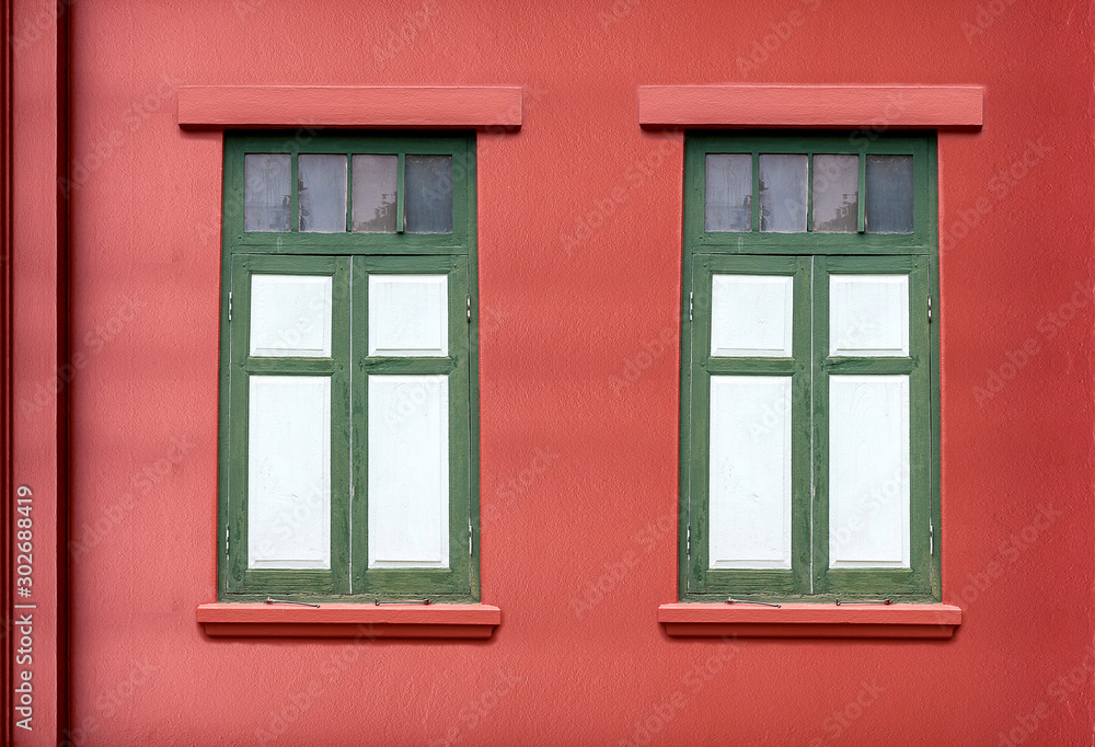 Fototapeta premium Traditional windows on bright red walls