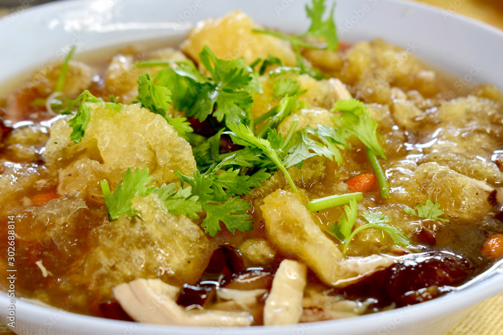 Bowl of fish maw soup on table food
