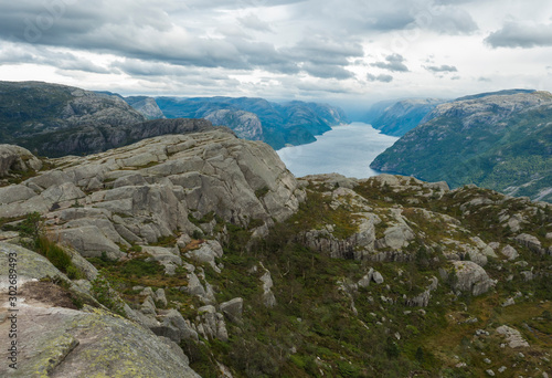View on fjord Lysefjord, next to Preikestolen massive cliff famous Norway viewpoint Moody sky, autumn day. Nature and travel background, vacation and hiking holiday concept. © Kristyna