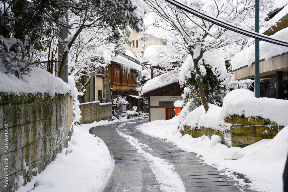 Snow on village road downtown street in the winter in Nagano, Japan