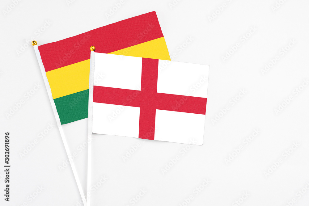 England and Ghana stick flags on white background. High quality fabric, miniature national flag. Peaceful global concept.White floor for copy space.
