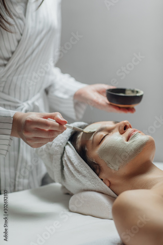 Cosmeotologist Applying a Facial Mask