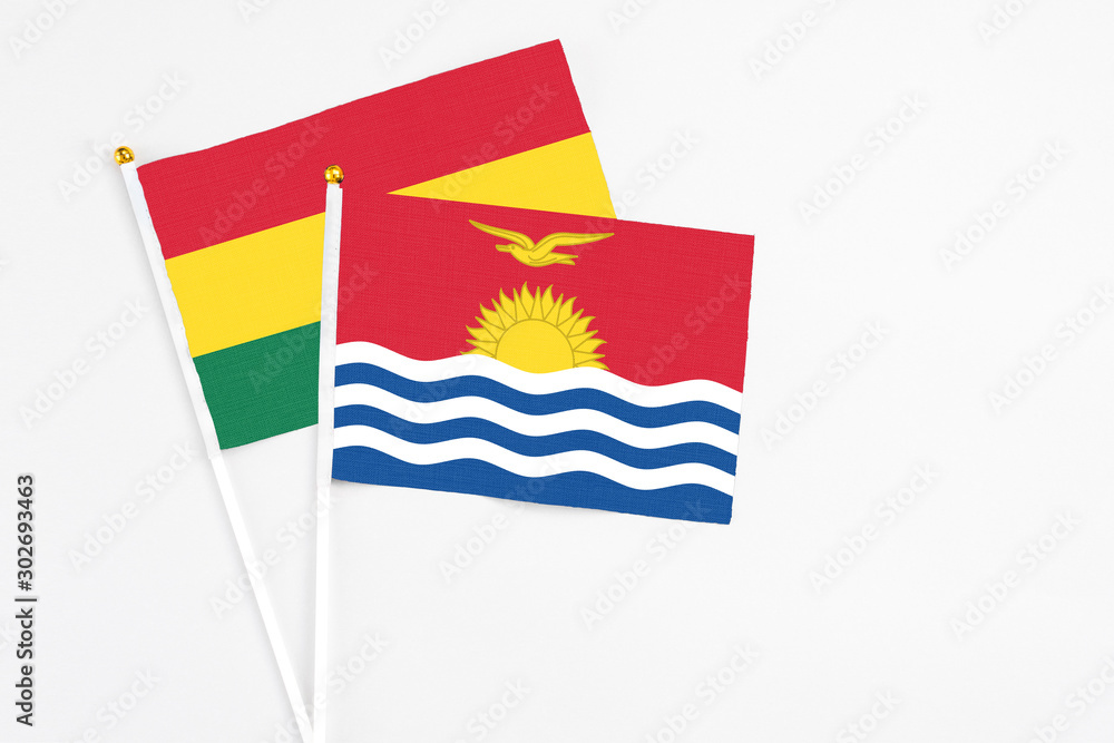 Naklejka premium Kiribati and Ghana stick flags on white background. High quality fabric, miniature national flag. Peaceful global concept.White floor for copy space.