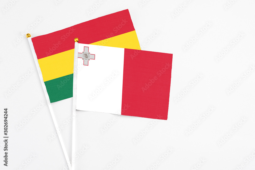 Malta and Ghana stick flags on white background. High quality fabric, miniature national flag. Peaceful global concept.White floor for copy space. Malta and Ghana stick flags on white background. High quality fabric, miniature national flag. Peaceful global concept.White floor for copy space.