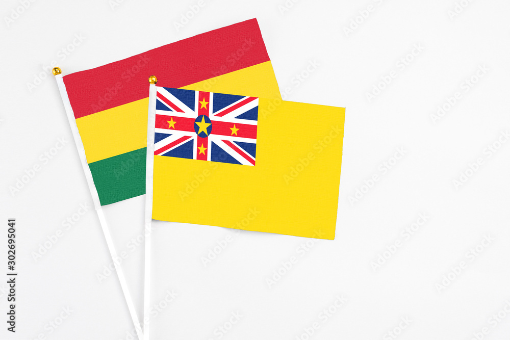 Niue and Ghana stick flags on white background. High quality fabric, miniature national flag. Peaceful global concept.White floor for copy space. Niue and Ghana stick flags on white background. High quality fabric, miniature national flag. Peaceful global concept.White floor for copy space.