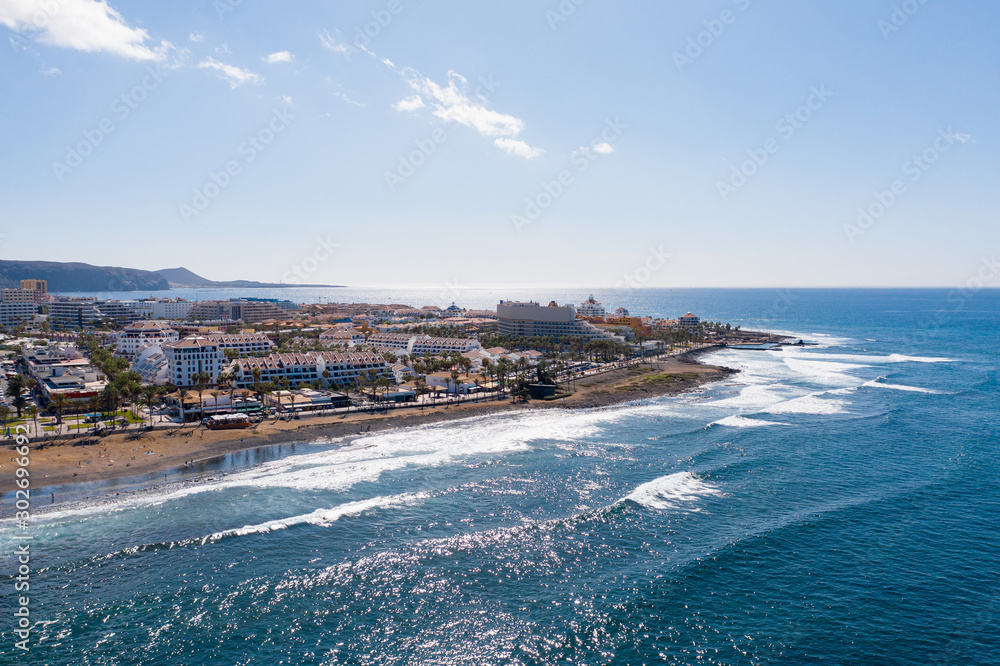 Aerial shot of Tenerife coastline near  Playa de las Americas. Beautiful landscape of Atlantic ocean with luxury hotels and restaurants