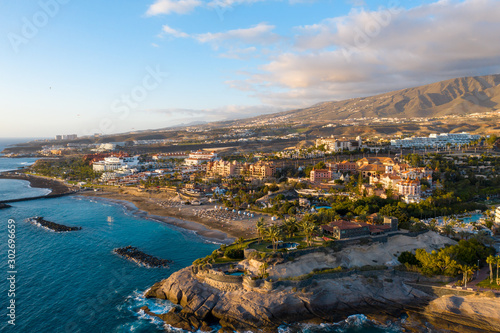 Aerial drone shot of Costa Adeje, South Tenerife, Spain. Beautiful golden hour landscape. Premuim beaches and luxury hotels area.