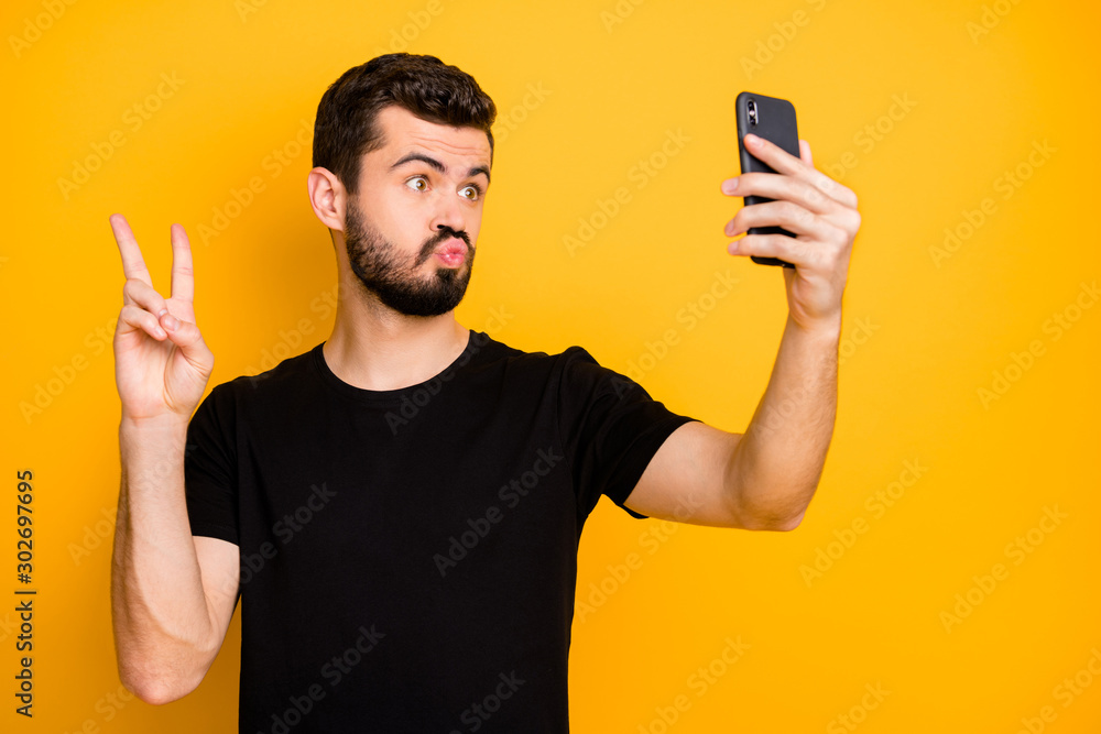 Portrait of funky guy blogger handsome lover have spring time trip video call make selfie show v-sign greet his followers wear black friday t-shirt isolated over shine color background Portrait of funky guy blogger handsome lover have spring time trip video call make selfie show v-sign greet his followers wear black friday t-shirt isolated over shine color background