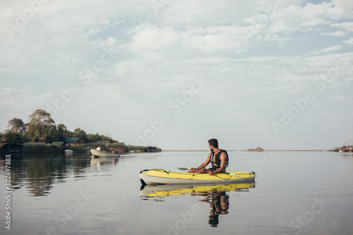 Handsome Young Man Kayaking © LStockStudio
