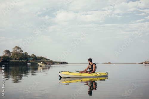 Handsome Young Man Kayaking