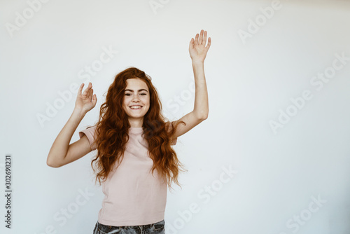 young student bounces and stretches her arms up background light © mnelen.com
