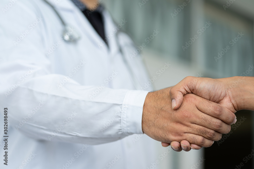 Close up of a doctor shake hands with the patient. Close up of a doctor shake hands with the patient.