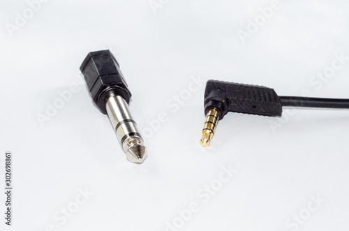 6.35 mm male to 3,5 mm female jack adapter and mii jack audio cable. Isolated on white.