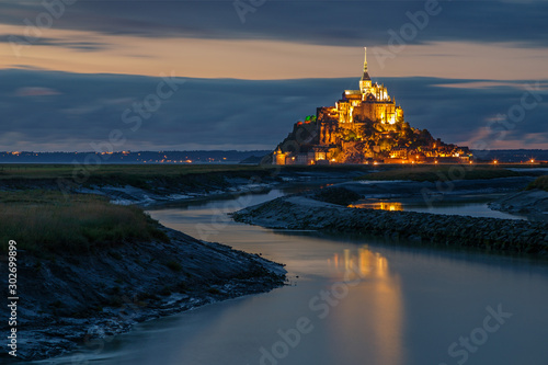 Normandy, France. The illuminated Mont Saint Michel is reflected on the water