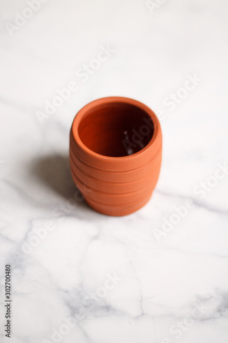 ceramic mug clay red on a light marble background top view
