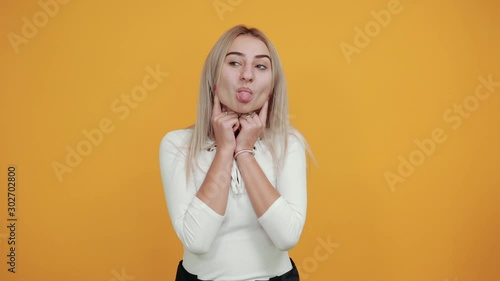 Young funny beautiful caucasian woman wearing nice white shirt puffing cheeks with funny face. Mouth inflated with air, crazy expression.