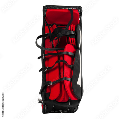 Red and black ice hockey goalie leg pads isolated on white background.