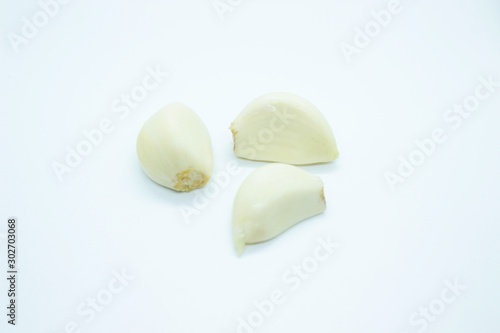 Garlic cloves plated on a white background