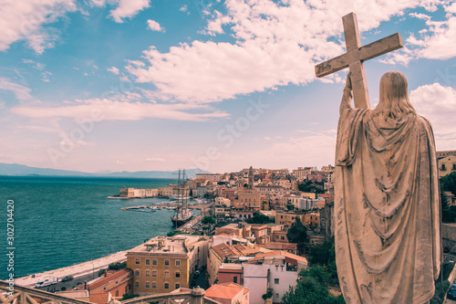 Christ statue overlooking the beautiful coastal town of Gaeta, Italy photo