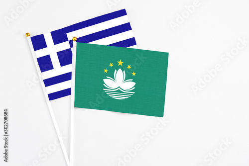 Macao and Greece stick flags on white background. High quality fabric  miniature national flag. Peaceful global concept.White floor for copy space.