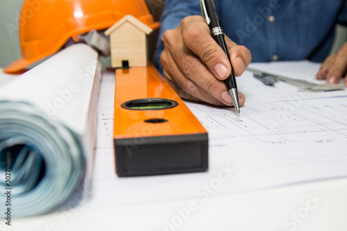Engineer and Architect drawings blueprint at Construction Site