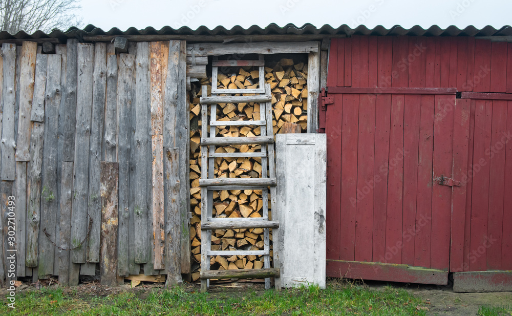 A full barn of chopped birch firewood stacked in a barn. Harvesting firewood for the winter.