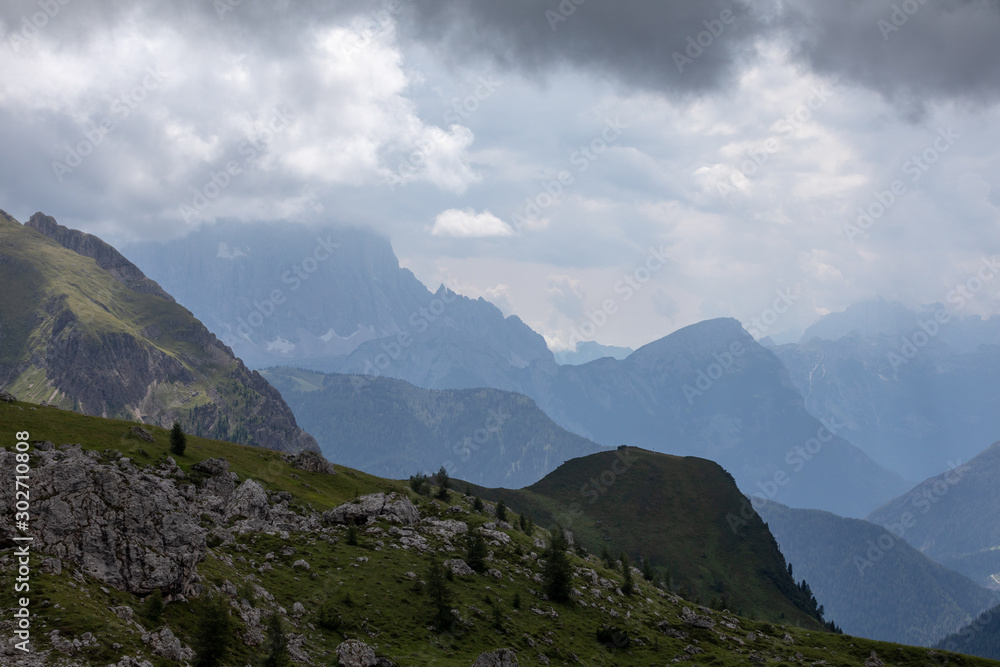 Fototapeta premium Clouds over the mountains. Mountain alpine landscape. Dolomites, Italy