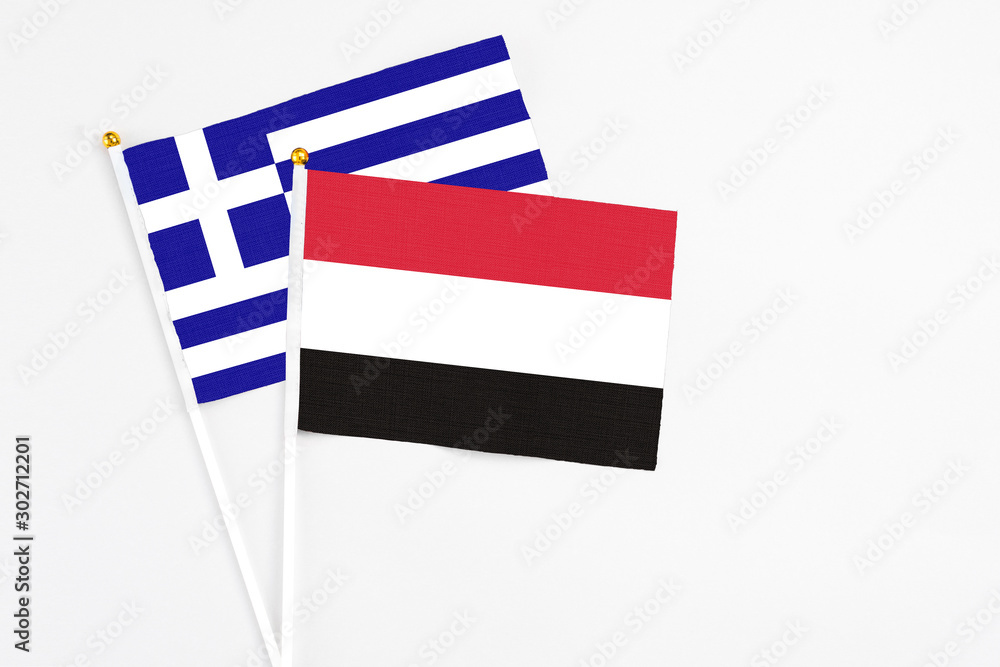 Yemen and Greece stick flags on white background. High quality fabric, miniature national flag. Peaceful global concept.White floor for copy space.