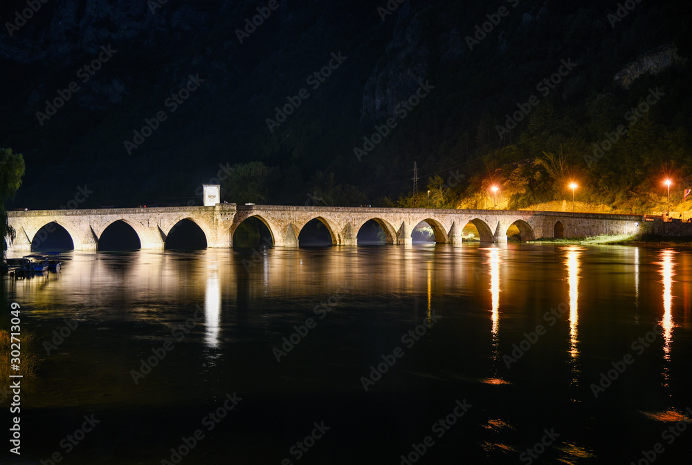 The Ottoman Mehmed Pasa Sokolovic Bridge in Visegrad,  Bosnia and Herzegovina during night