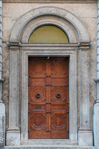 wooden door with beautiful wooden ornaments in the historical part of the Italian capital